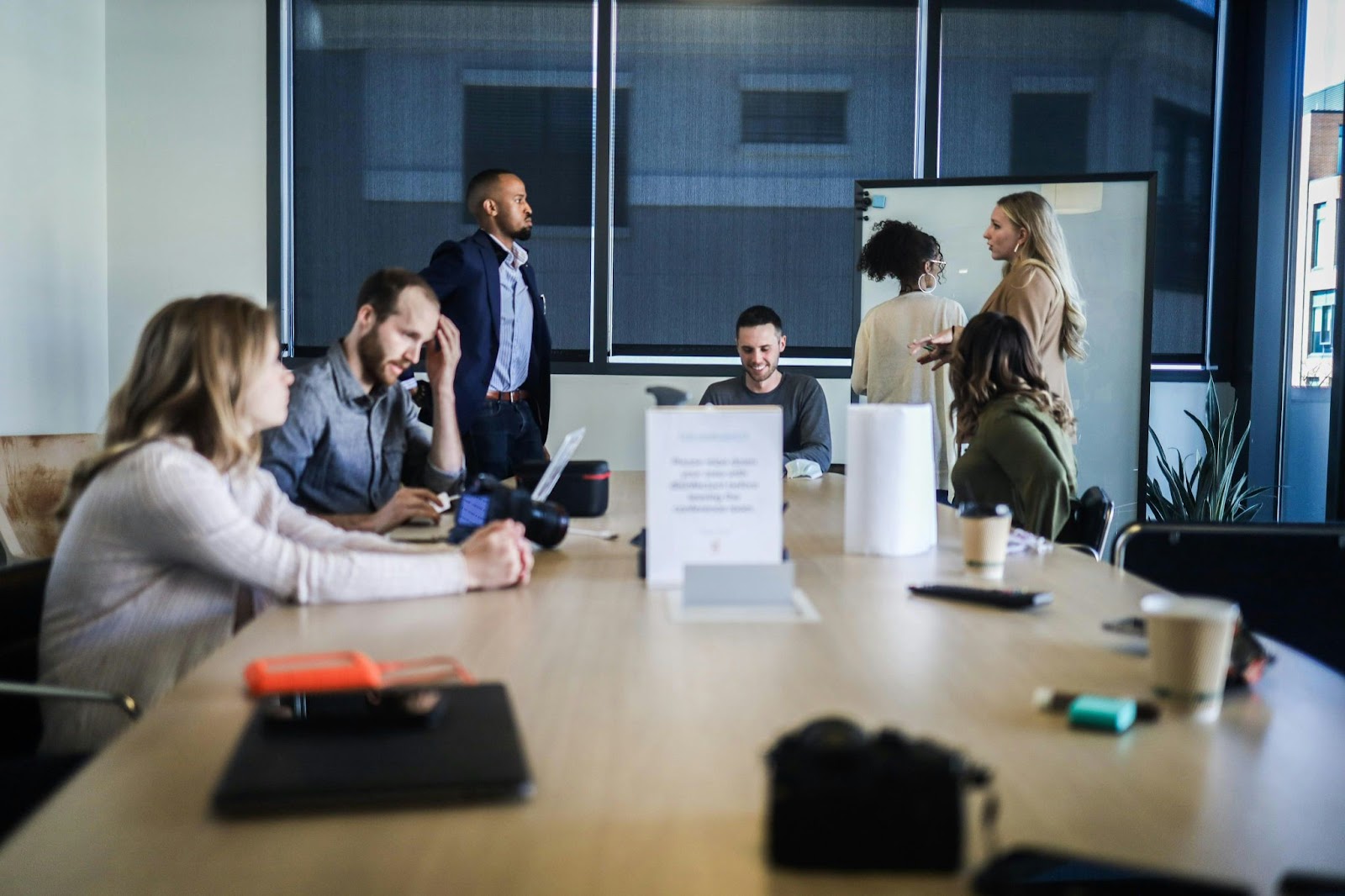 People sitting at a table. They seem to be discussing solutions to a problem.