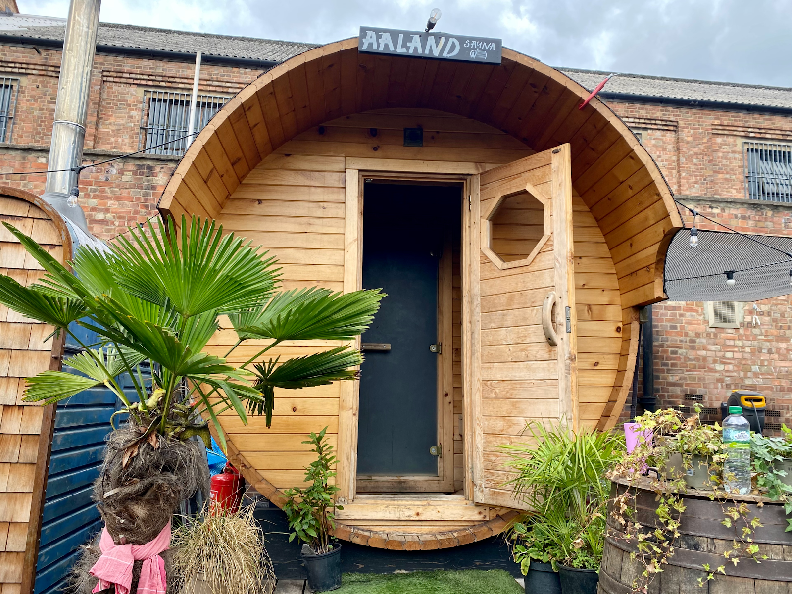 One of the saunas at Hackney Wicks Community Baths. It is wooden and round, with the front door open