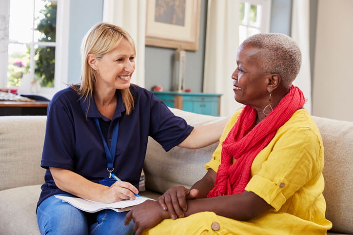 A speech therapist helping an adult in therapy. 