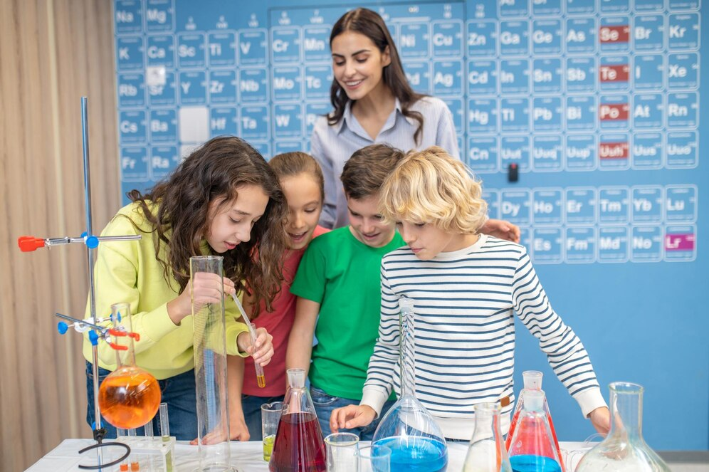 Teacher demonstrating science experiments to students.