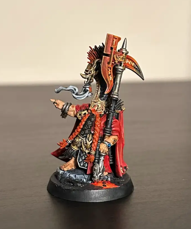 A small figurine of a warrior holding an axe  Description automatically generated