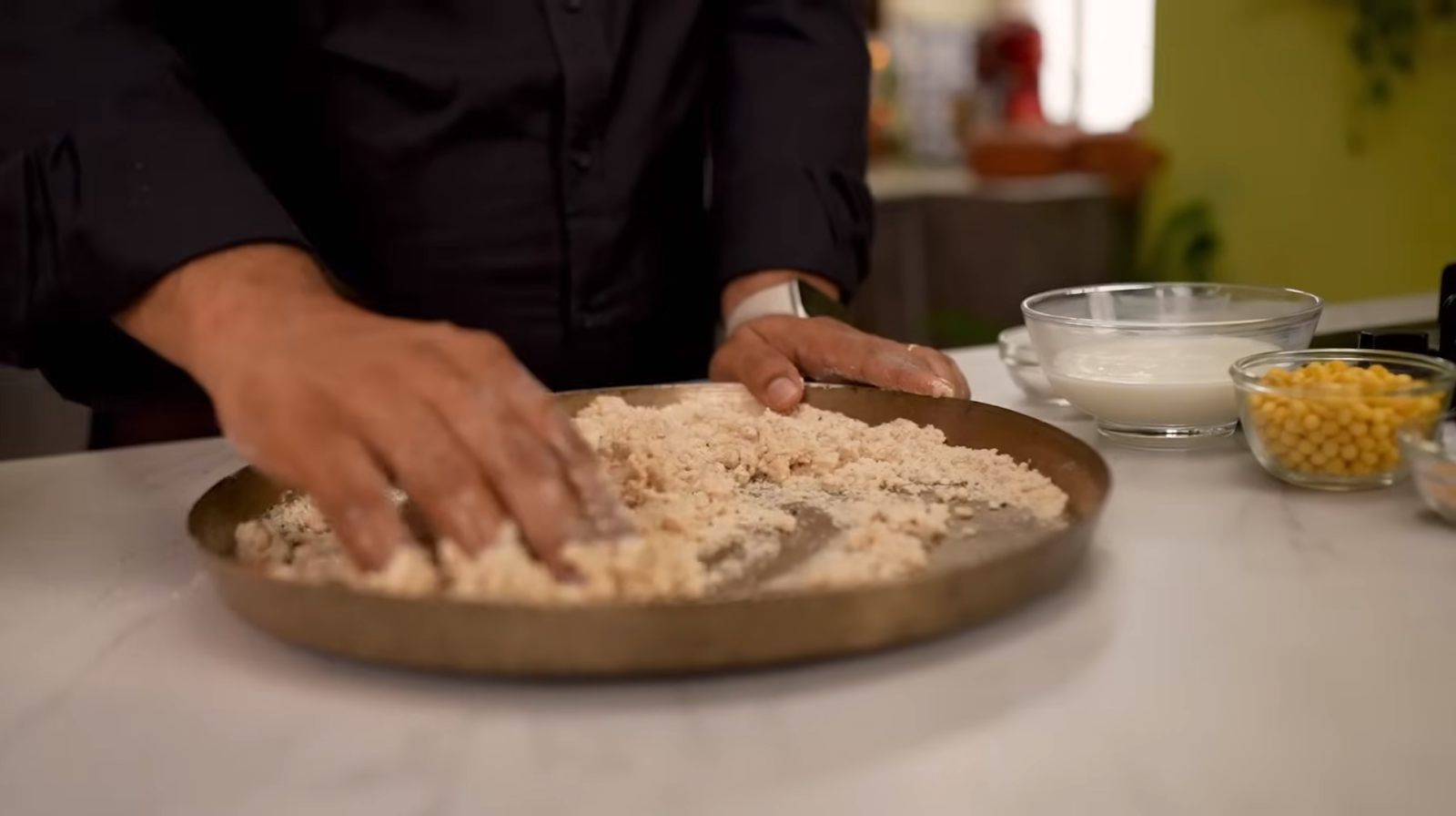 Mixing ingredients for puri dough in a bowl to form a semi-tight dough.