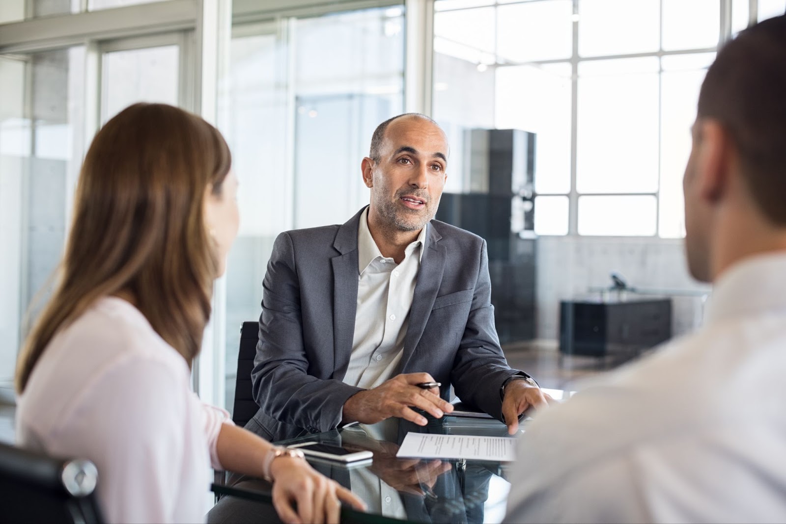 A financial advisor is discussing a proposal with clients. 