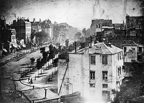 A grainy, black and white photograph titled 'View from the Window at Le Gras' taken by Nicéphore Niépce in 1826.