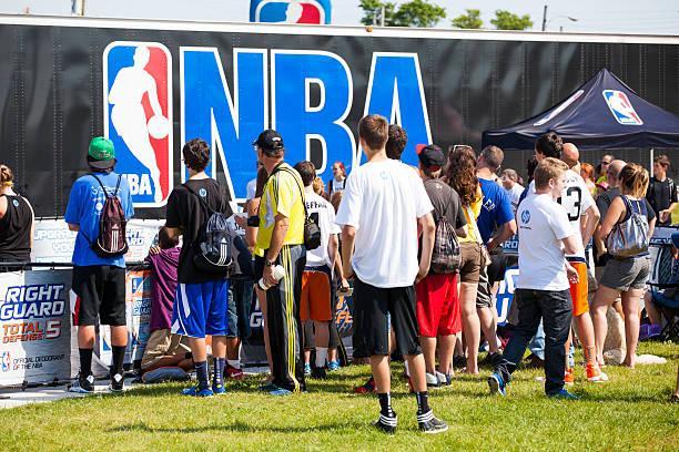 Crowd of People at the NBA 3X Halifax, Nova Scotia, Canada - September 8, 2012: Crowd of people at the NBA 3X in downtown at the Commons in Halifax, Nova Scotia.  Many people of different ages attend with NBA logo visible on trailer in background.  The NBA 3X is a public event that tours across Canada.  Local players can register to play 3 x 3 basketball during the event. nba basketball stock pictures, royalty-free photos & images