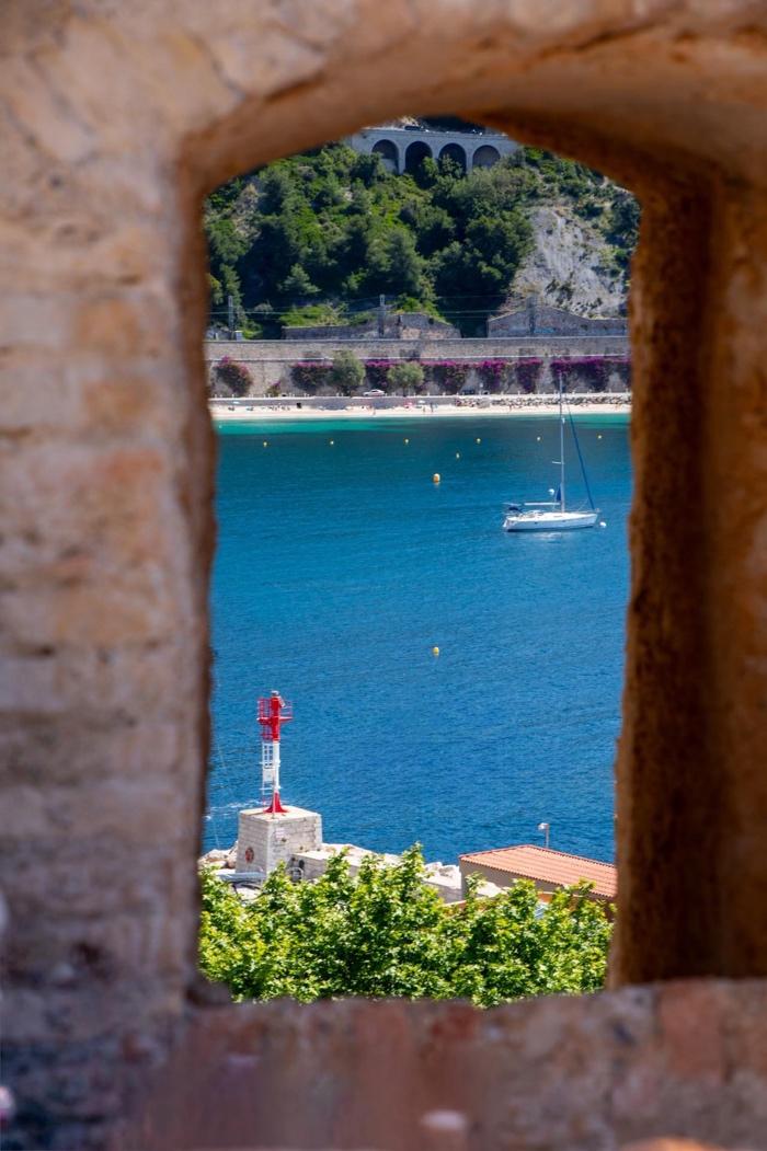 A view of a body of water from a window

Description automatically generated