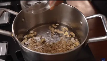 Cashews and melon seeds boiling in water.