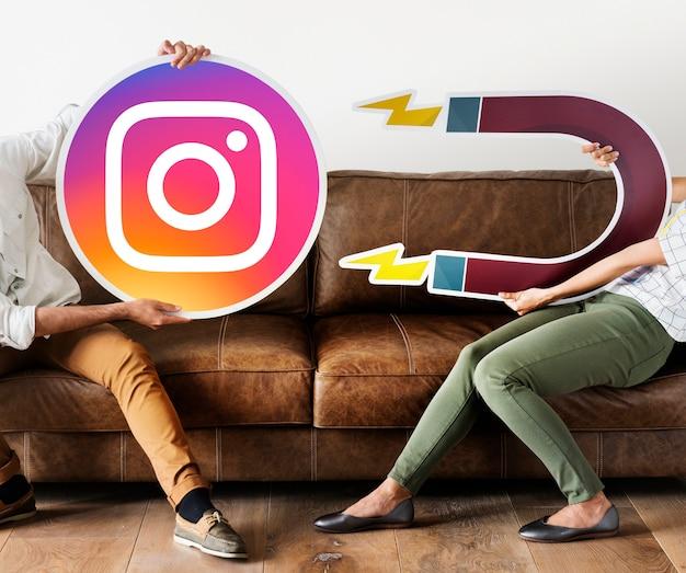 People holding an Instagram icon