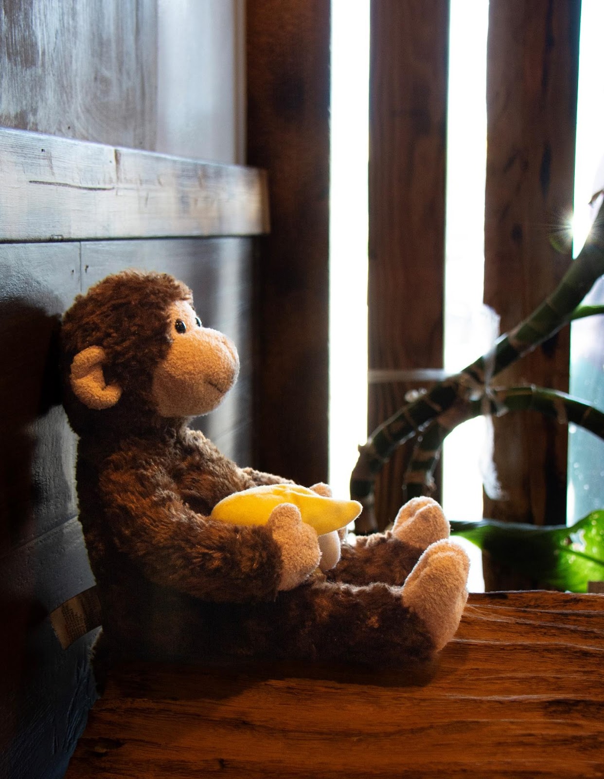 A stuffed monkey holding a banana

Description automatically generated