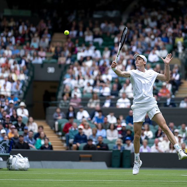 Photo by Jannik Sinner in Wimbledon. May be an image of tennis, racket, stadium and text.