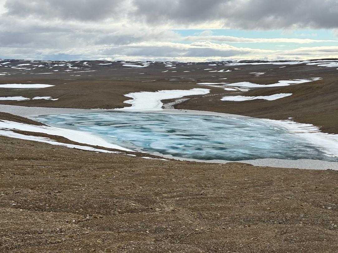 A frozen lake in a desert

Description automatically generated