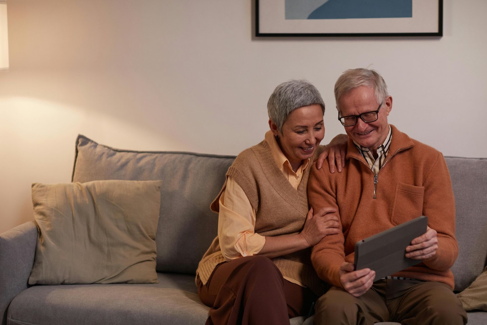 Two elderly people engaging with a mobile tablet