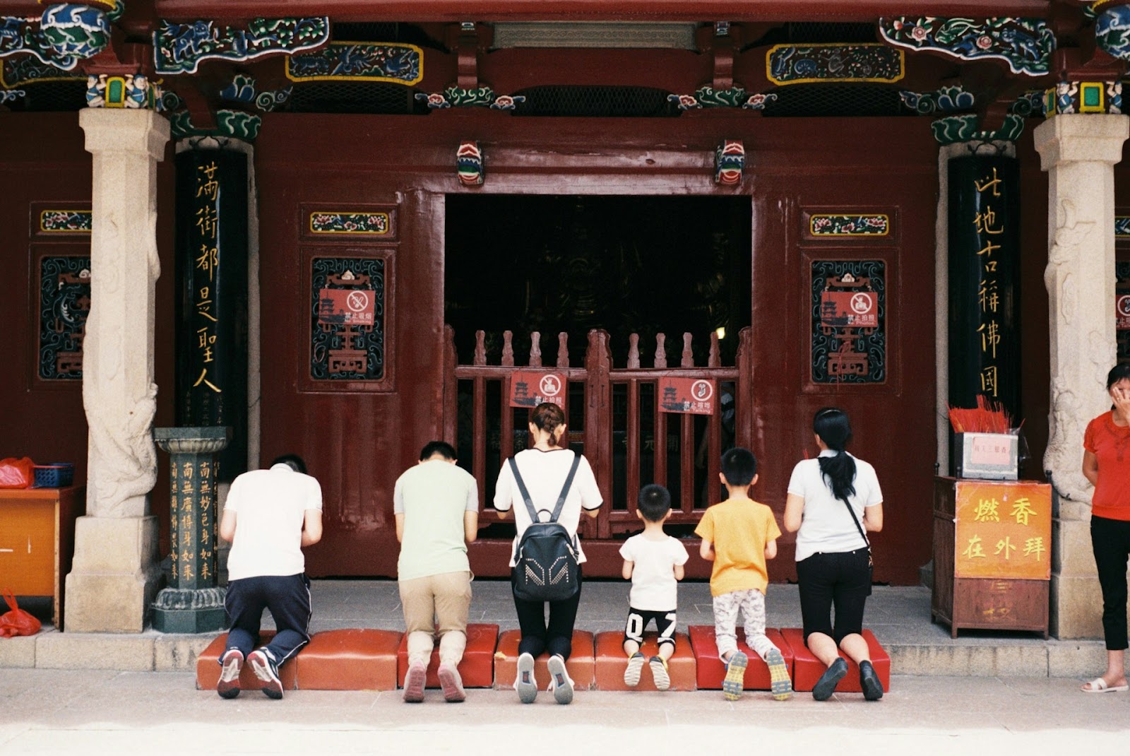 All members of a Chinese family kneeling down and showing respect