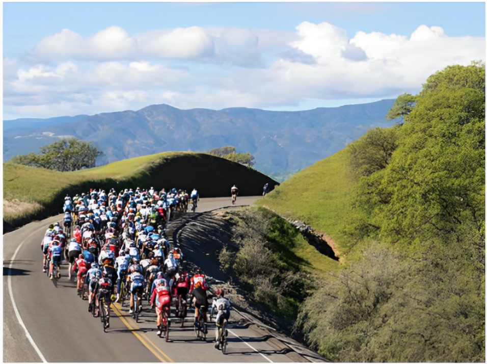 A group of people riding bicycles on a road

Description automatically generated