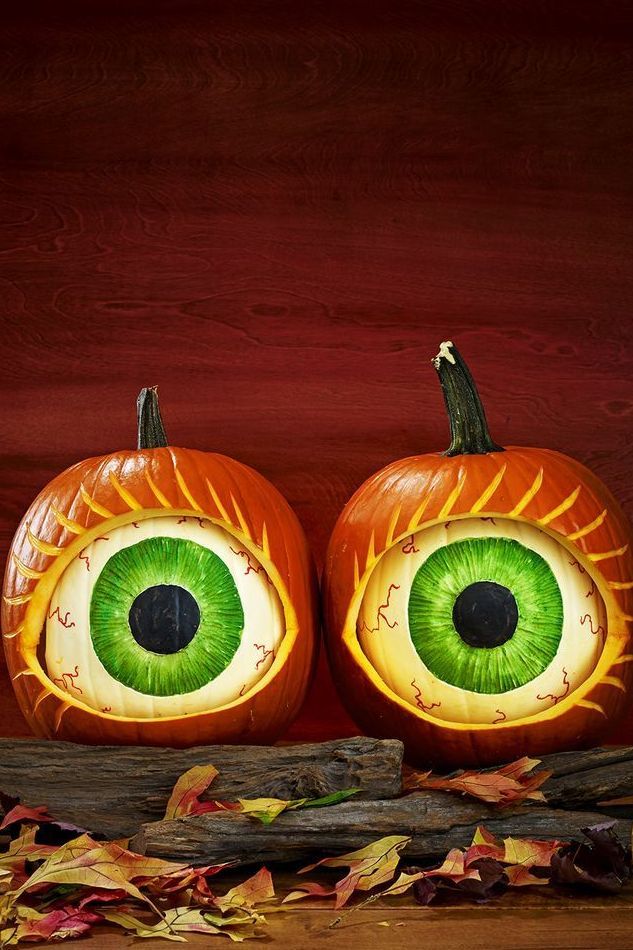 pumpkin carving ideas, two pumpkins with large pumpkin designed eyes inside