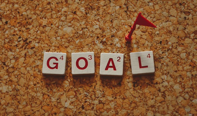 Tiles on a table spell out the word 'goal'.