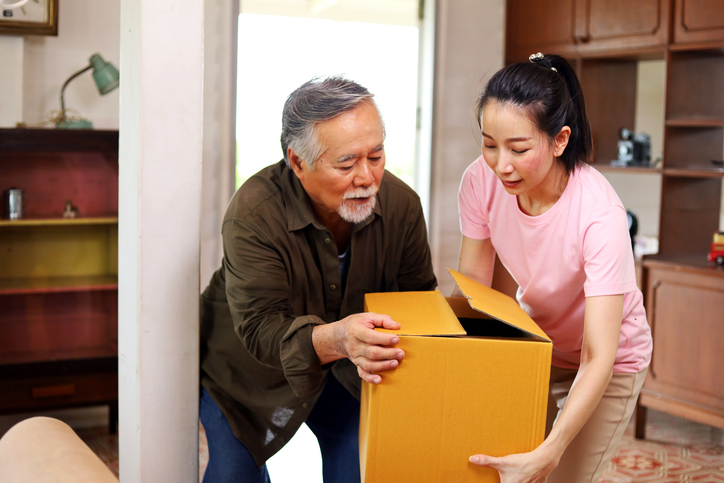 Father and daughter preparing items for storage. 