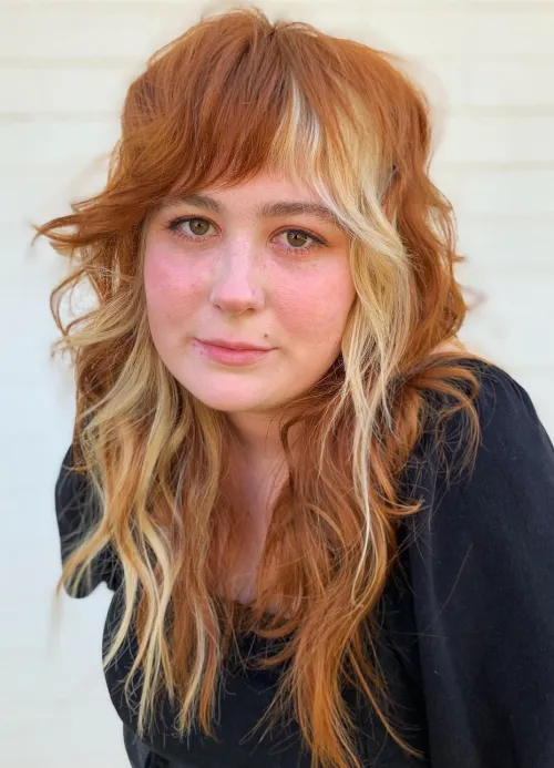 Picture of a lady wearing Voluminous Wolf Haircut with Wispy Layers