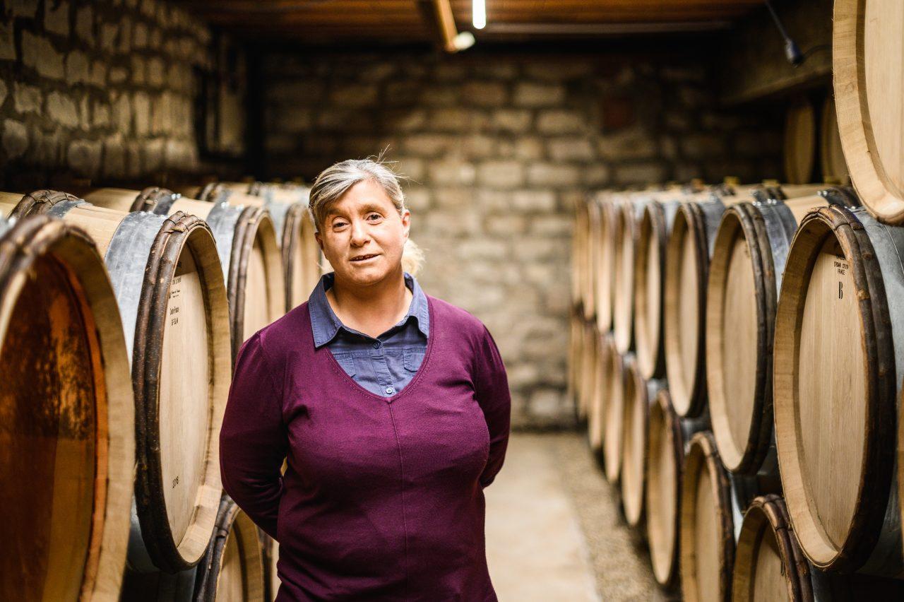 A person standing in a room with barrels

Description automatically generated
