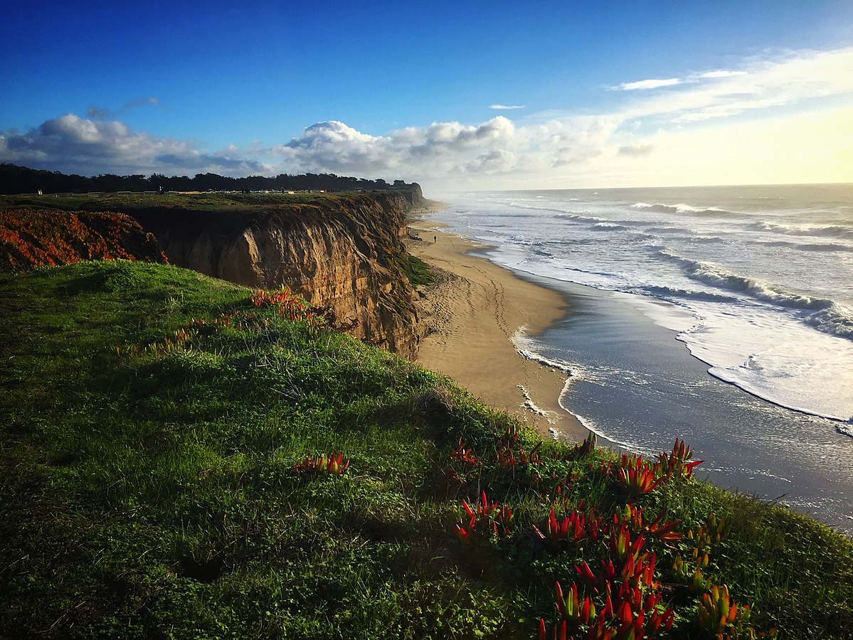 Massive lush cliffs along the shore