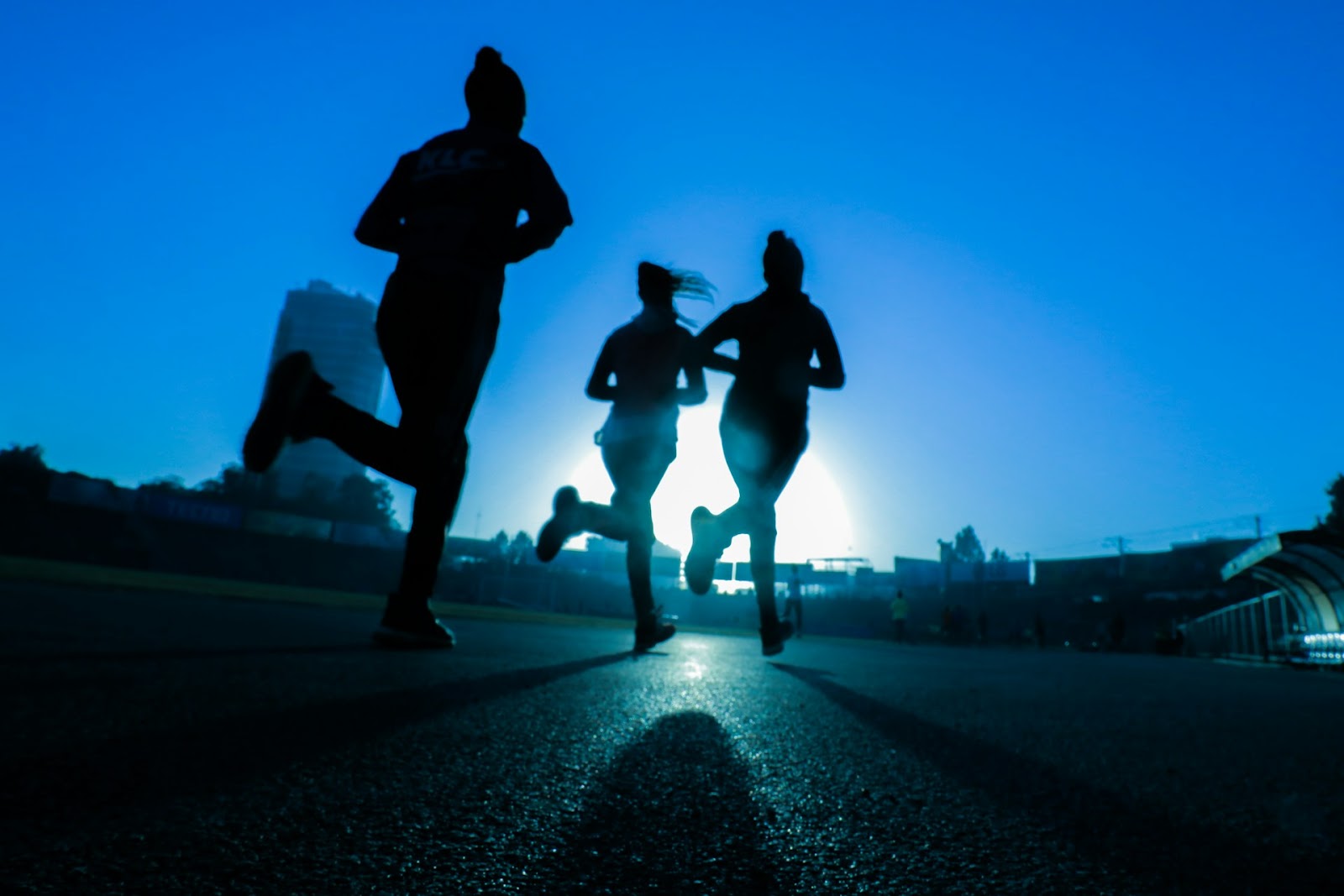 Three women running as part of their regular exercise. 