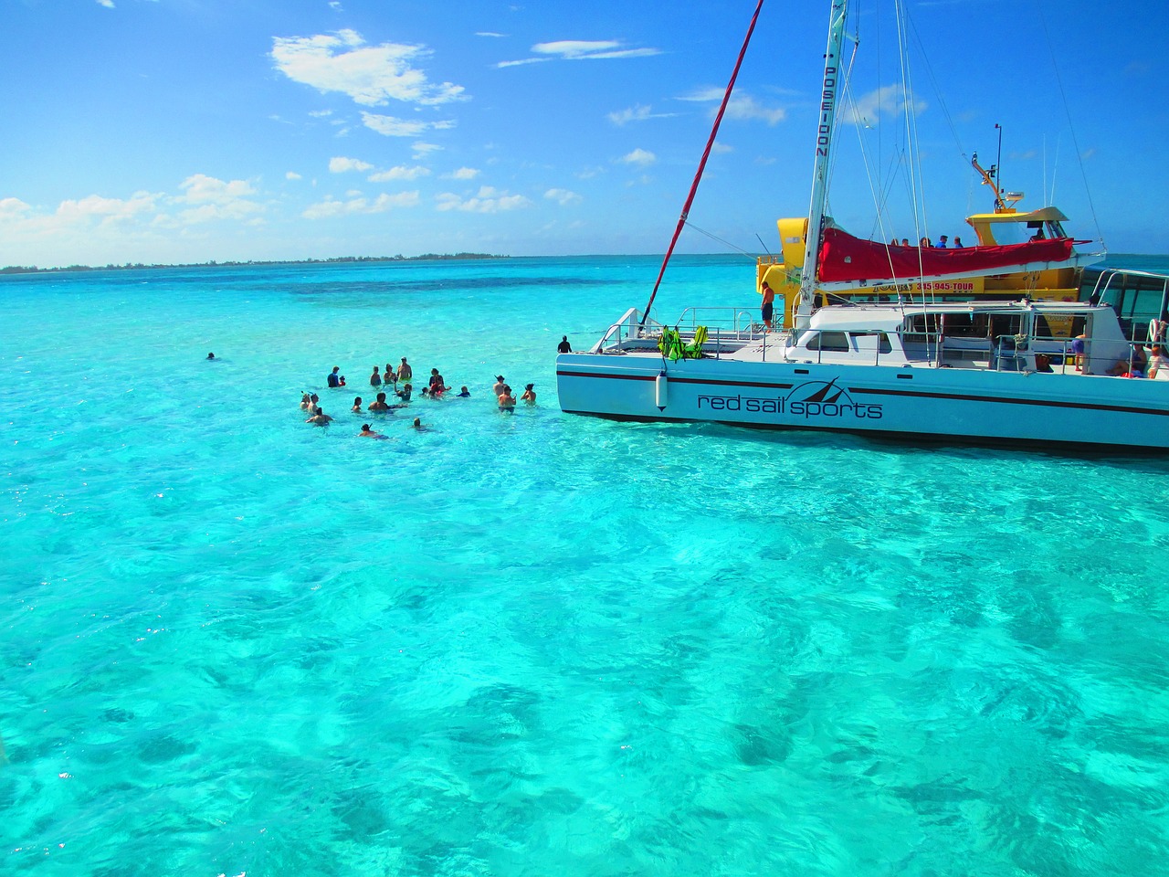 People enjoying themselves on the beautiful beach of the Cayman Island of Cali Colombia.