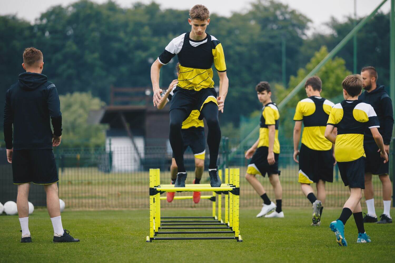 A group of boys at summer soccer camp doing agility drills during practice