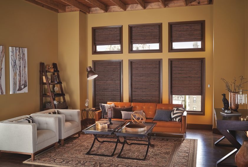 Living room area with brown woven shades covering UV rays