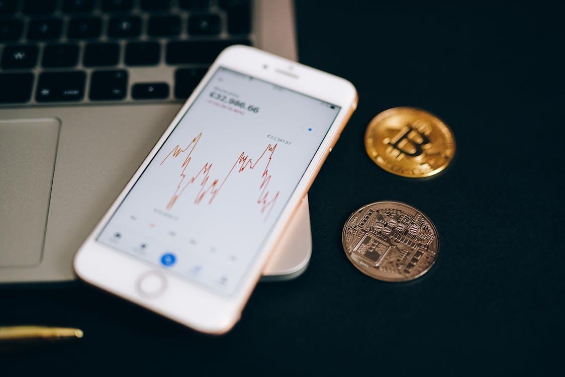 Free Close Up Shot of a Smartphone and Bitcoins Stock Photo