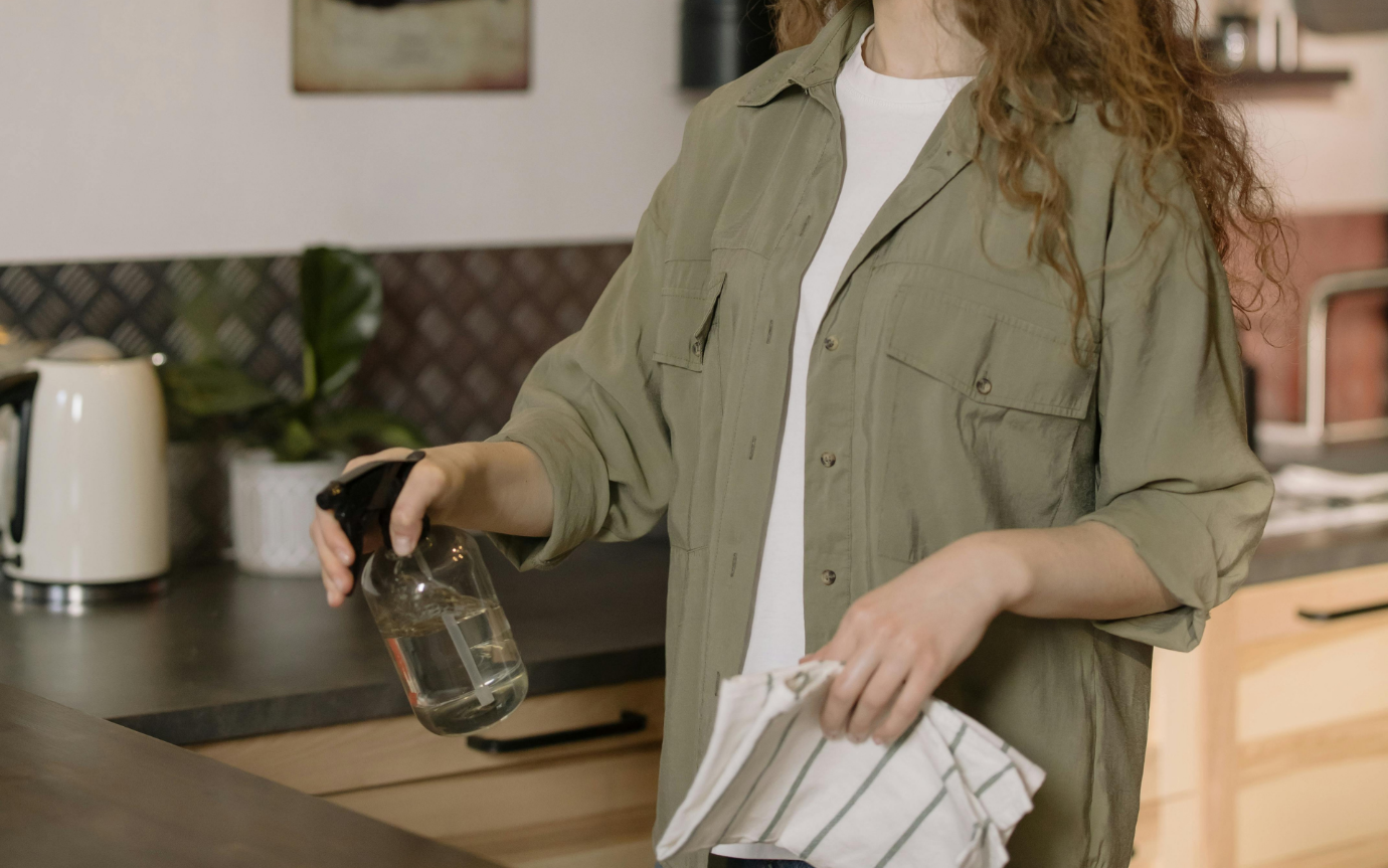 A person holding a bottle of water and a napkinDescription automatically generated