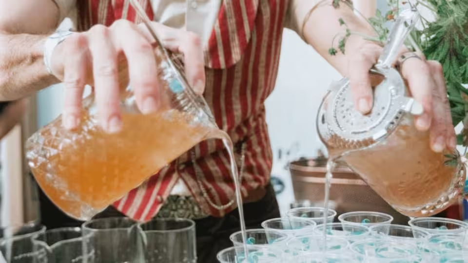 Costumed bartender pouring drinks