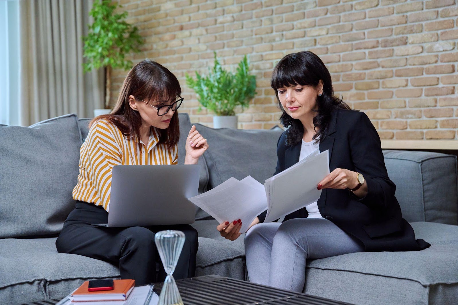 A licensed insolvency trustee explaining to a client how Alberta's bankruptcy laws work