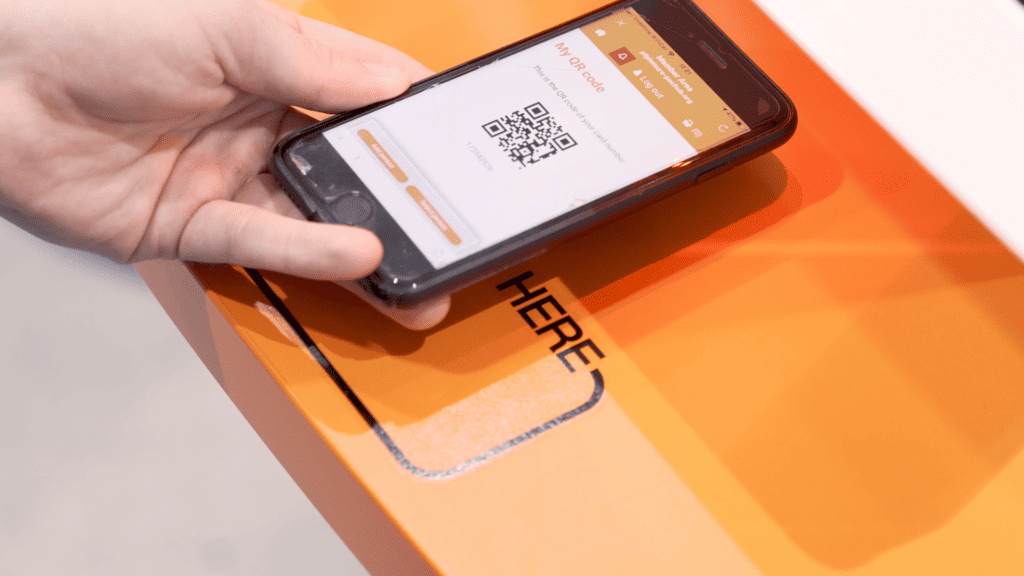 A person using a mobile phone to scan a qr code showing a digital prototype being user tested.