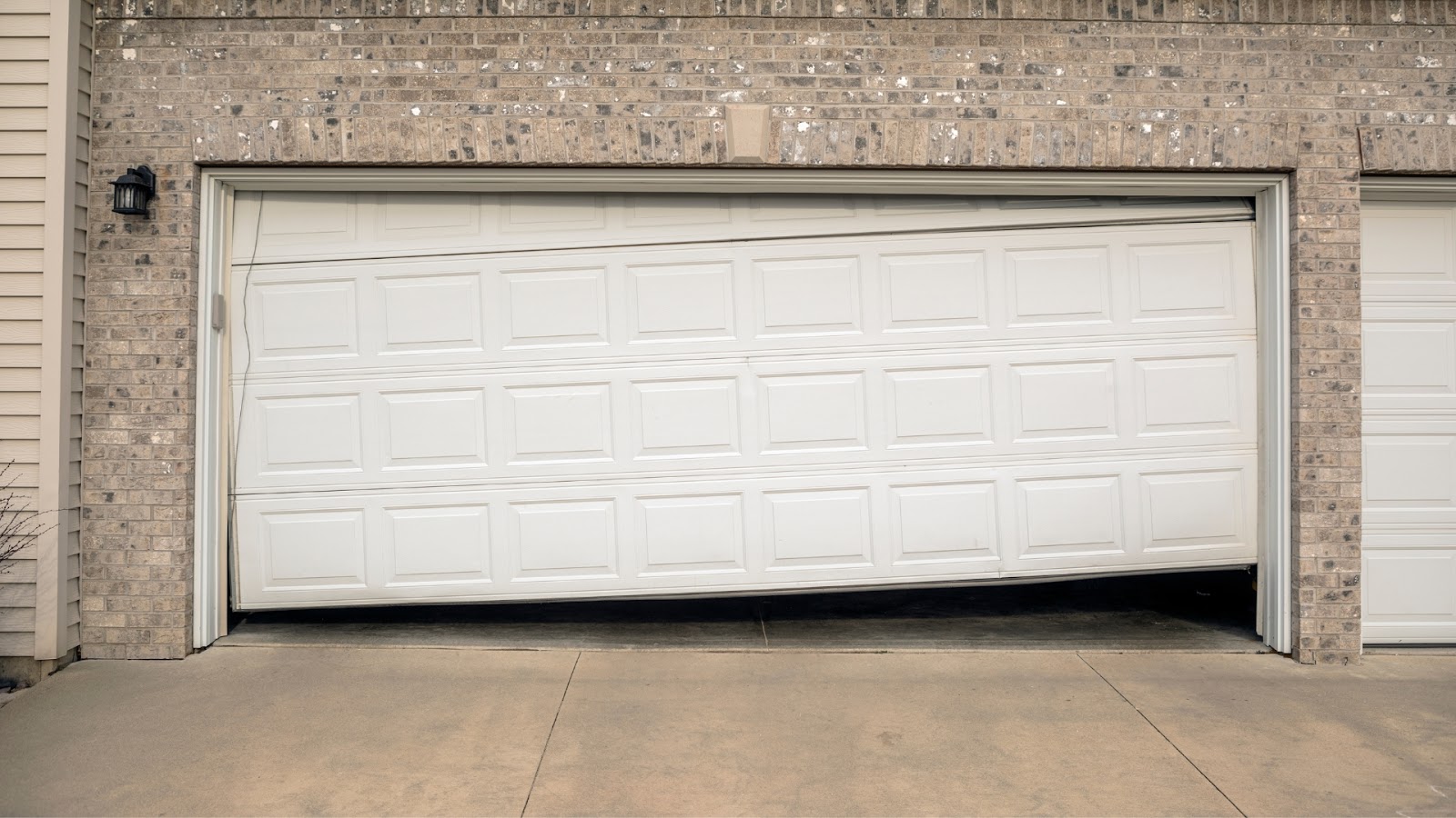 A residential garage door that is off-balanced and making noise