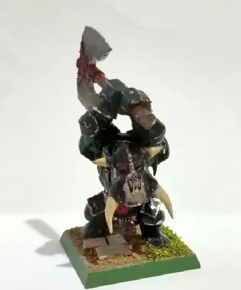A toy figurine of a warrior holding an axe Description automatically generated