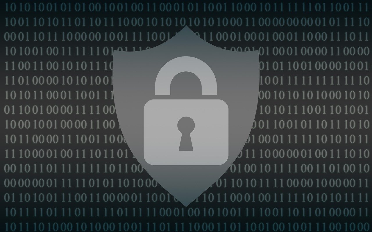 A digital image of a shield with a padlock on it, set against a dark background with binary code.