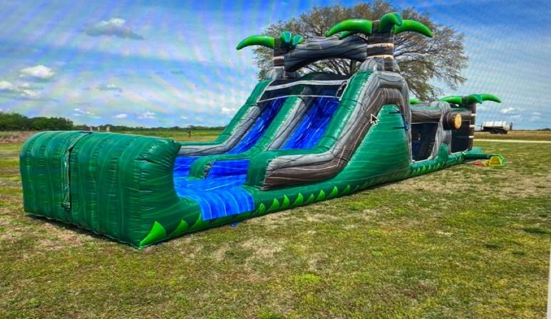 A large inflatable slide on grass

Description automatically generated