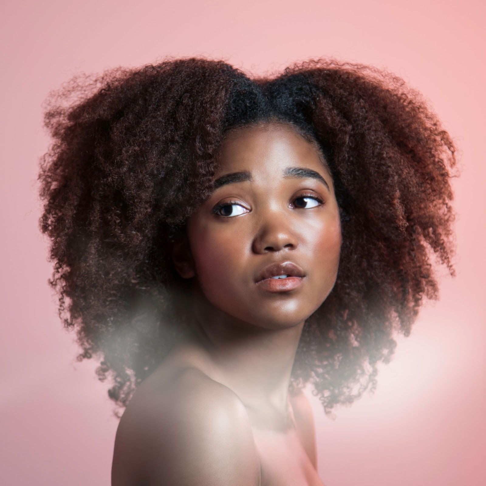 Stunning young black woman with perfectly glowing skin after applying a lavender sugar face scrub