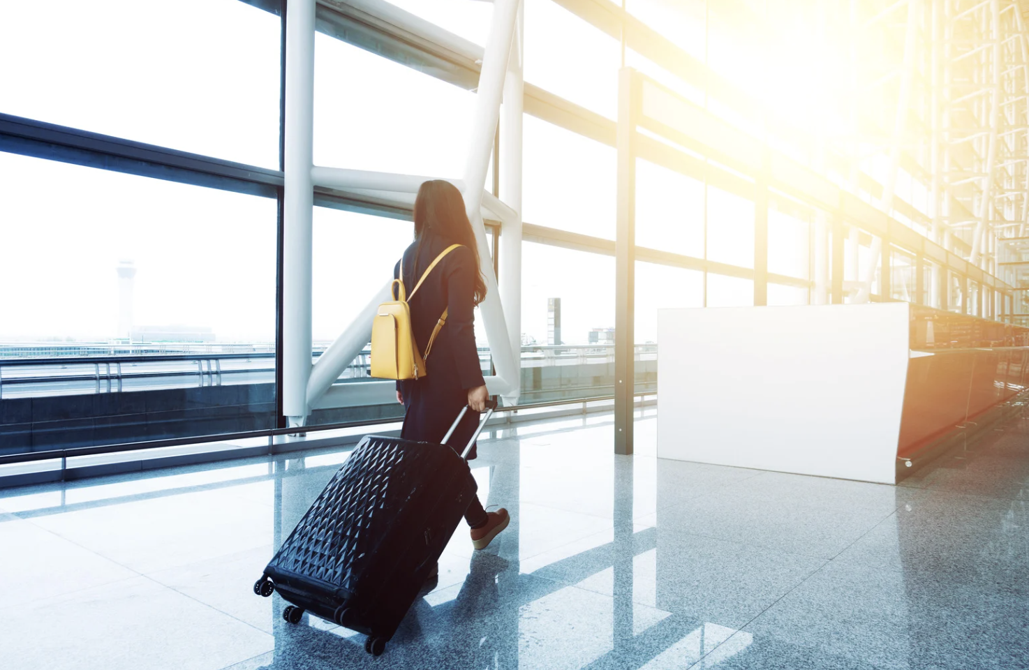 A person in an airport with luggage 