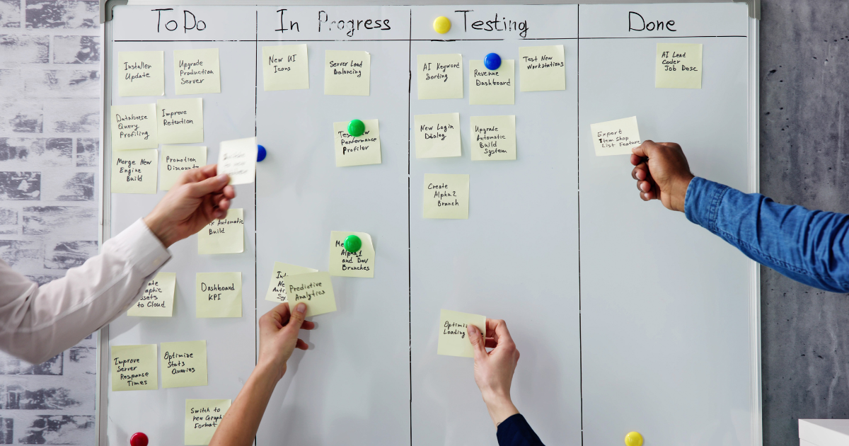 Team of professionals in a analyzing graphs and charts of Agile enterprise coaching strategies.