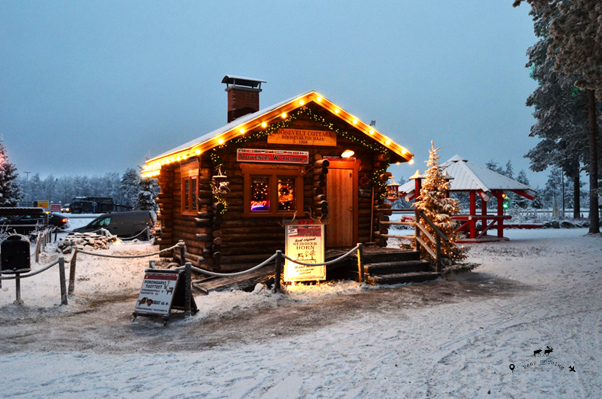 One of the typical wooden houses with Christmas decorations and lights inside Santa Claus' village.