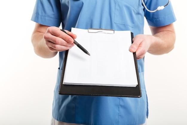 Free photo doctor's hand holding a pen and clipboard with blank paper