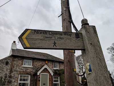 Wooden walkers sign for North Downs Way