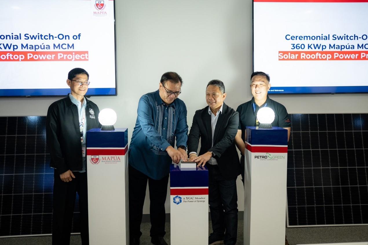 A group of men standing in front of a solar panel

Description automatically generated