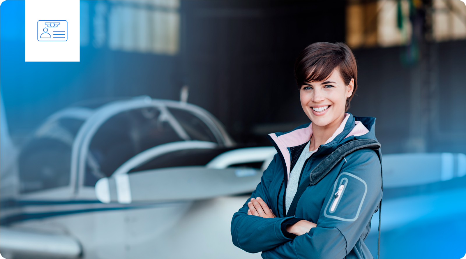 A woman stands in front of a training airplane.