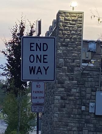A sign on the side of a road Description automatically generated