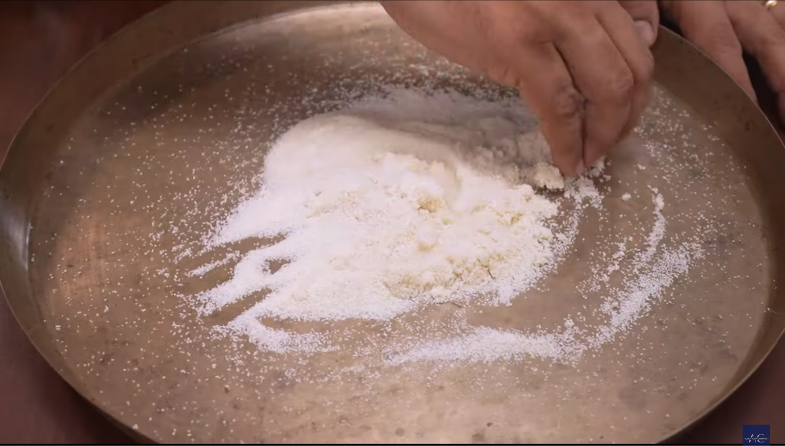 Mixing suji with hot water in a bowl to prepare dough for Aloo Ki Puri.
