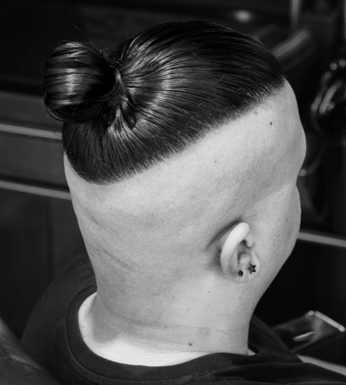 Picture of a man wearing Skin Fade and Man Bun Hairstyle