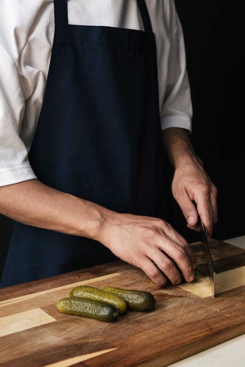 Free A Chef Cutting Pickled Cucumbers Stock Photo