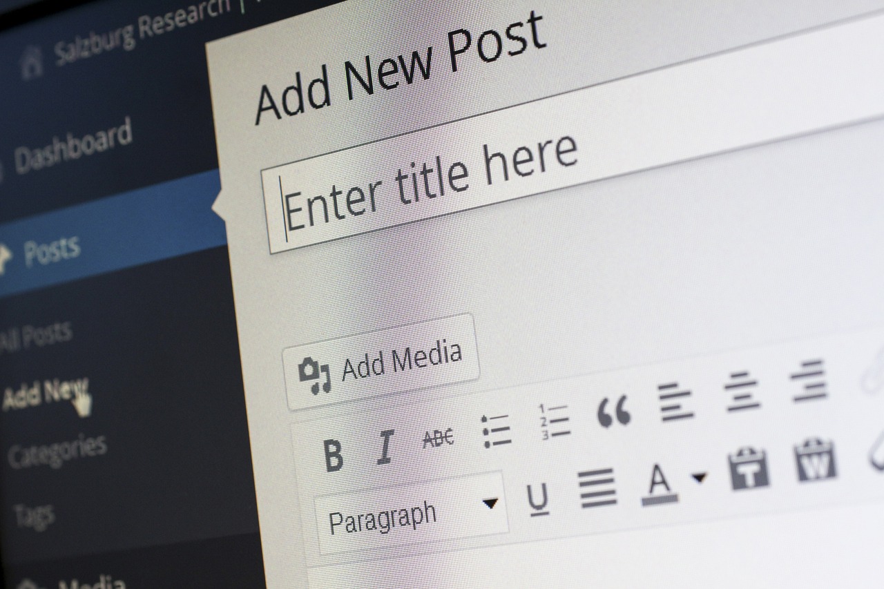A close-up of a new blog post screen with options to enter a title, add media, and format text.